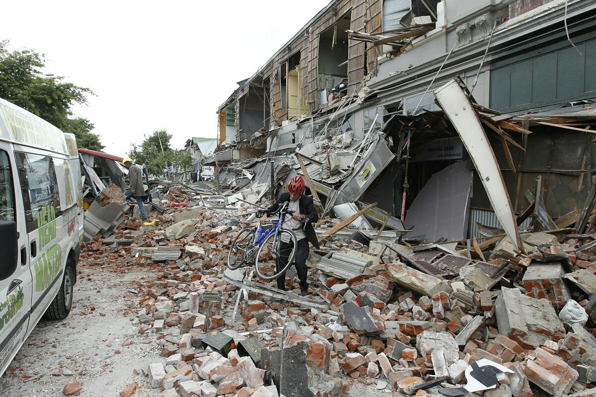 Brick walls collapse on a street in Christchurch, New Zealand during an earthquake in 2011. 