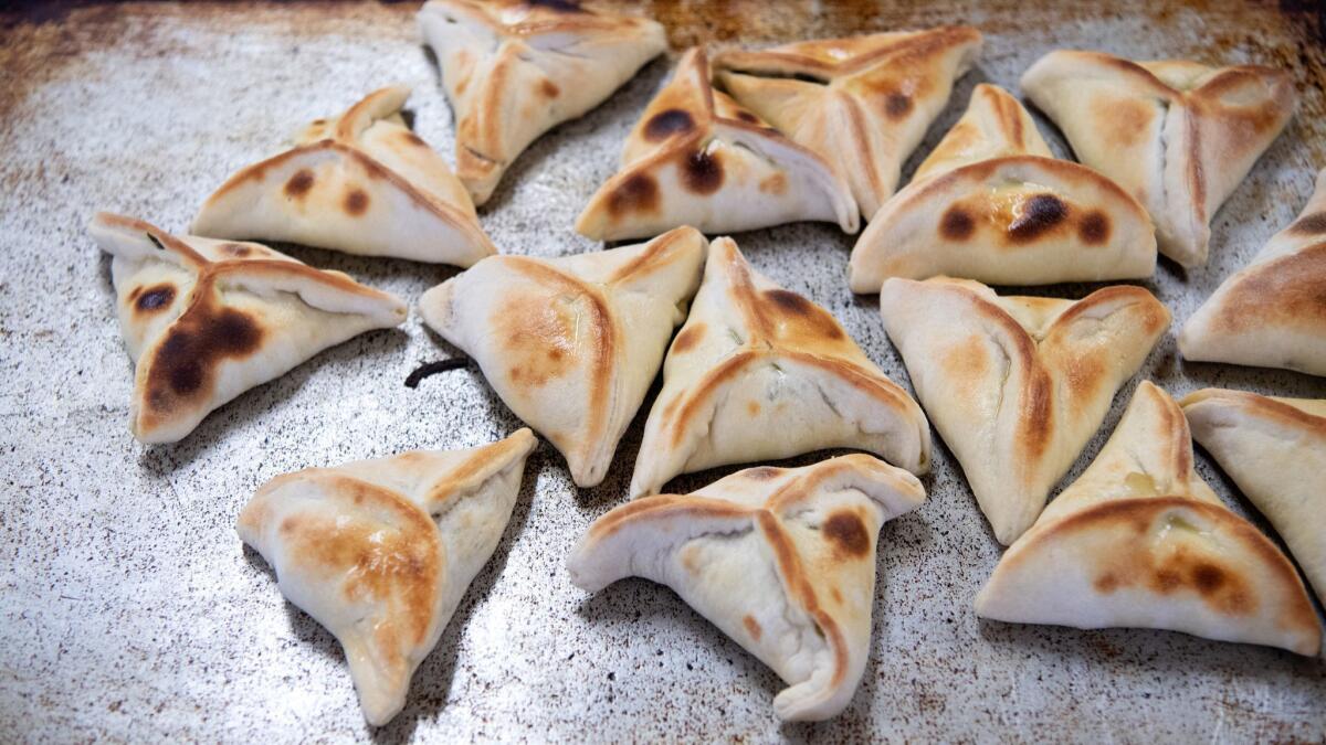 Freshly baked spinach fatayer at Forn Al Hara restaurant in Anaheim.