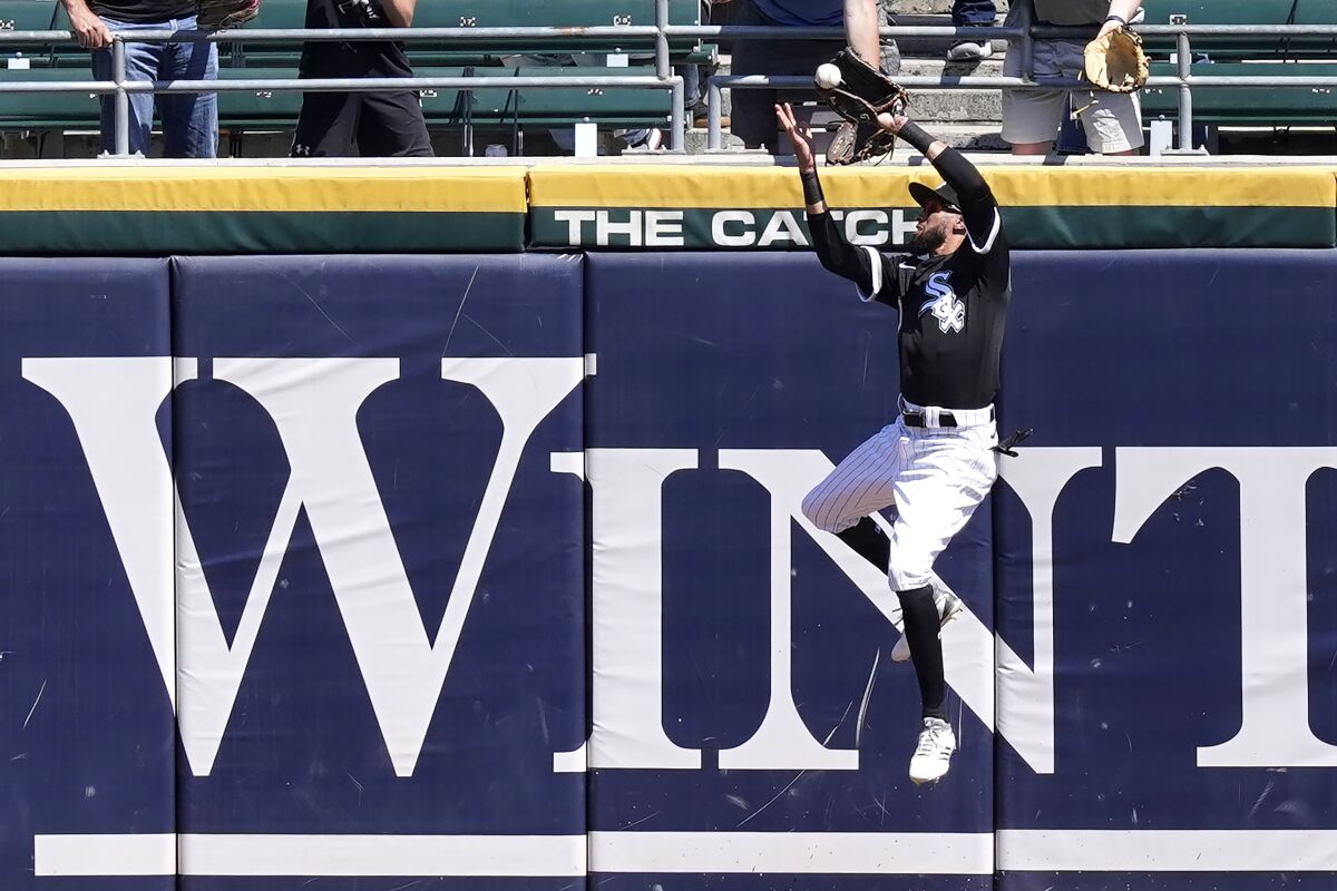 Chicago White Sox's Billy Hamilton makes a leaping catch of Minnesota Twins' Kyle Garlick's deep fly ball with the bases loaded during the fourth inning of a baseball game Thursday, May 13, 2021, in Chicago. (AP Photo/Charles Rex Arbogast)