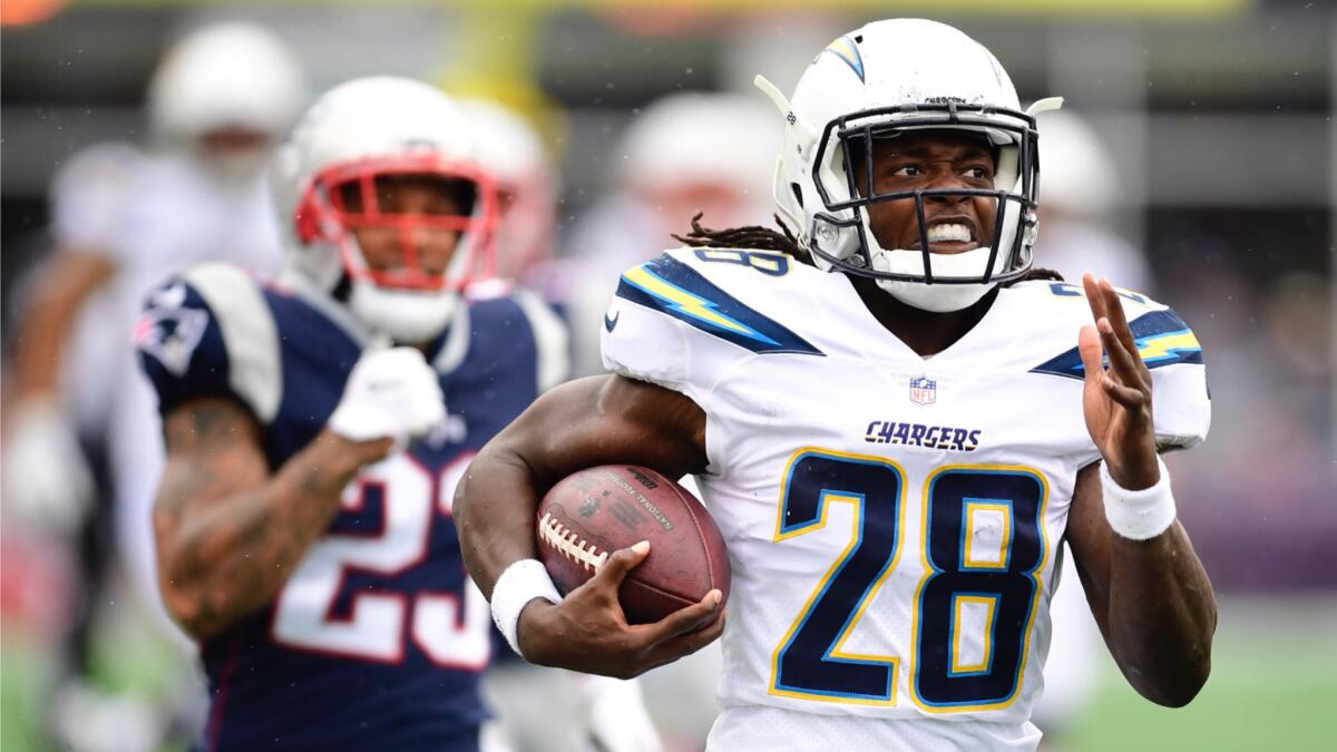 Chargers running back Melvin Gordon runs for a touchdown as Patriots strong safety Patrick Chung gives chase.
