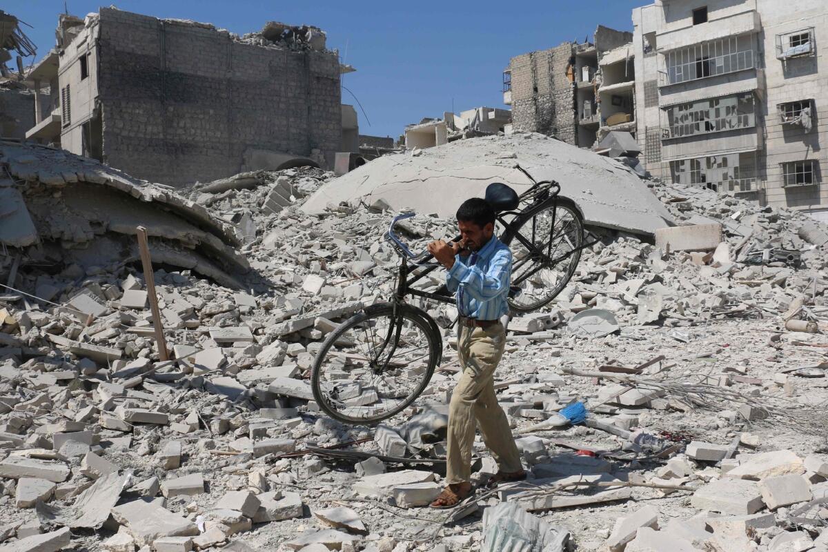 A Syrian man makes his way through the rubble of destroyed buildings after a reported airstrike on a rebel-held neighborhood of the northern city of Aleppo on Sept. 11, 2016.