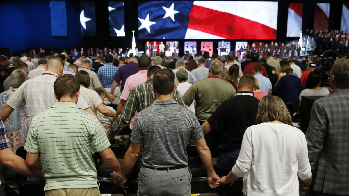 Participants pray for America at the 2018 annual meeting of the Southern Baptist Convention at the Kay Bailey Hutchison Dallas Convention Center in Dallas.