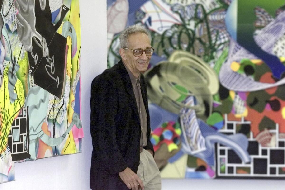 U.S. artist Frank Stella poses with his work in 2001.