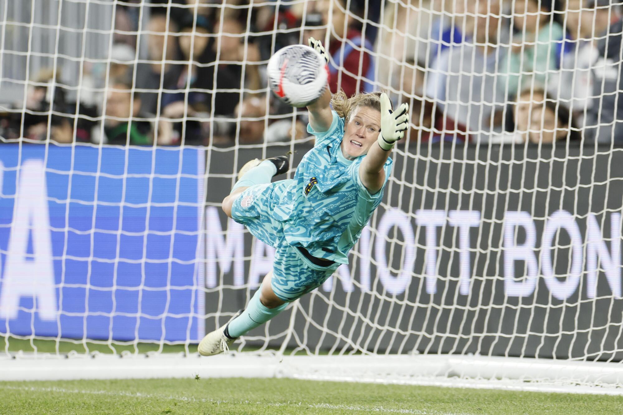 U.S. goalkeeper Alyssa Naeher dives to make a save during a match against Canada in the SheBelieves Cup in April.