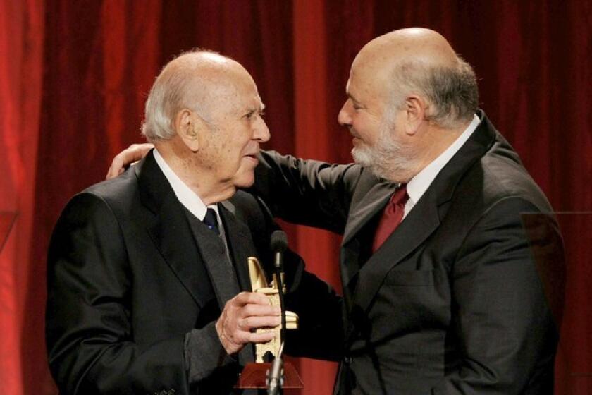 Director Carl Reiner presents his son Rob with the best inter-generational film award for "Flipped."