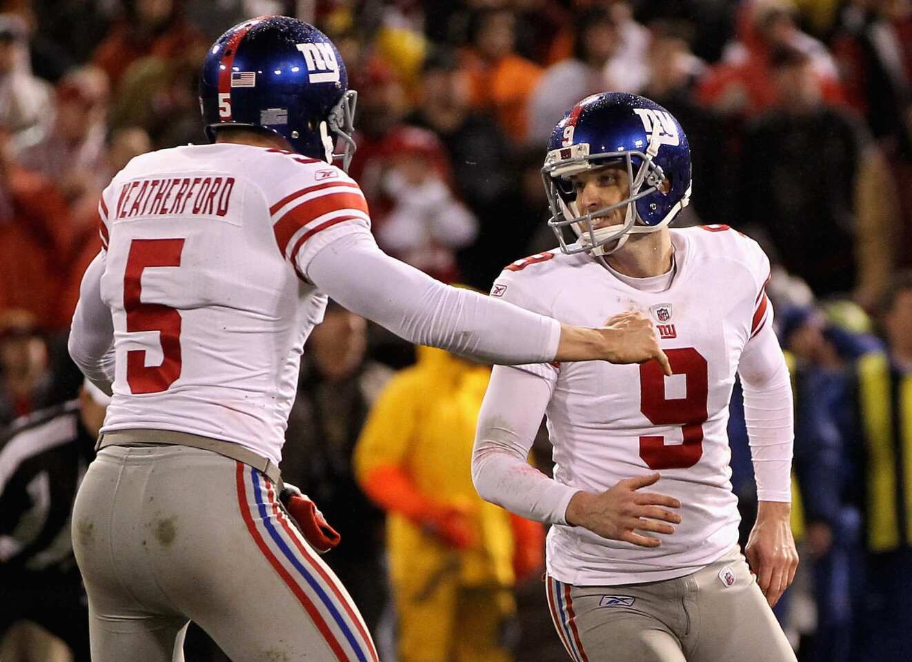 Kicker Lawrence Tynes (9) and holder Steve Weatherford celebrate after Tynes hit the game-winning field goal in overtime for a 20-17 victory over the San Francisco 49ers in the NFC championship game on Sunday at Candlestick Park.