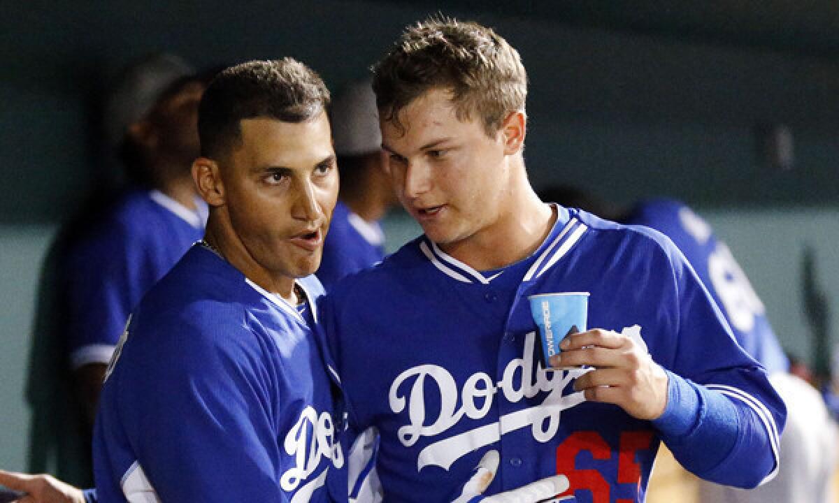 Dodgers shortstop Alex Guerrero, left, is congratulated by outfielder Joc Pederson after hitting a grand slam against the Cincinnati Reds in a Cactus League game March 5. Pederson made the trip to Australia but is starting the 2014 season in the Dodgers' minor league system.