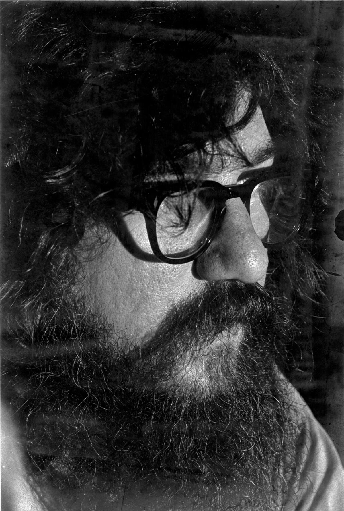 Close-up of Gerald Locklin, with thick glasses, shaggy hair and beard