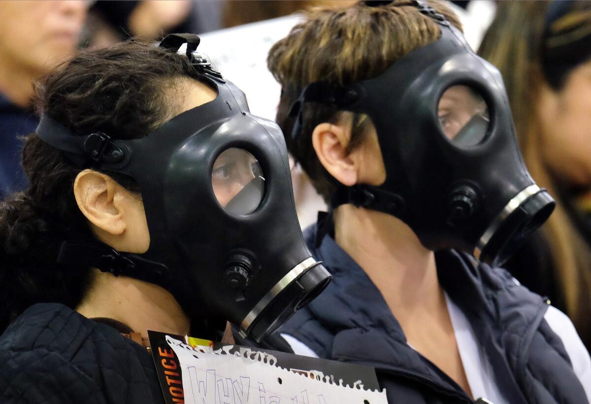 Protestors wearing gas masks attend a hearing on Jan. 23 regarding the gas leak near Porter Ranch.