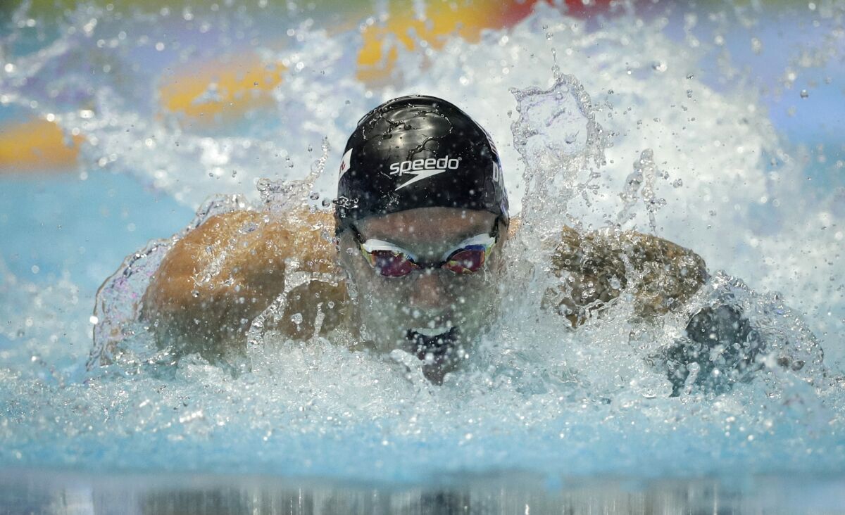 Caeleb Dressel of the U.S. set a world record in the men's 100-meter butterfly semifinals at the world swimming championships Friday in Gwangju, South Korea.