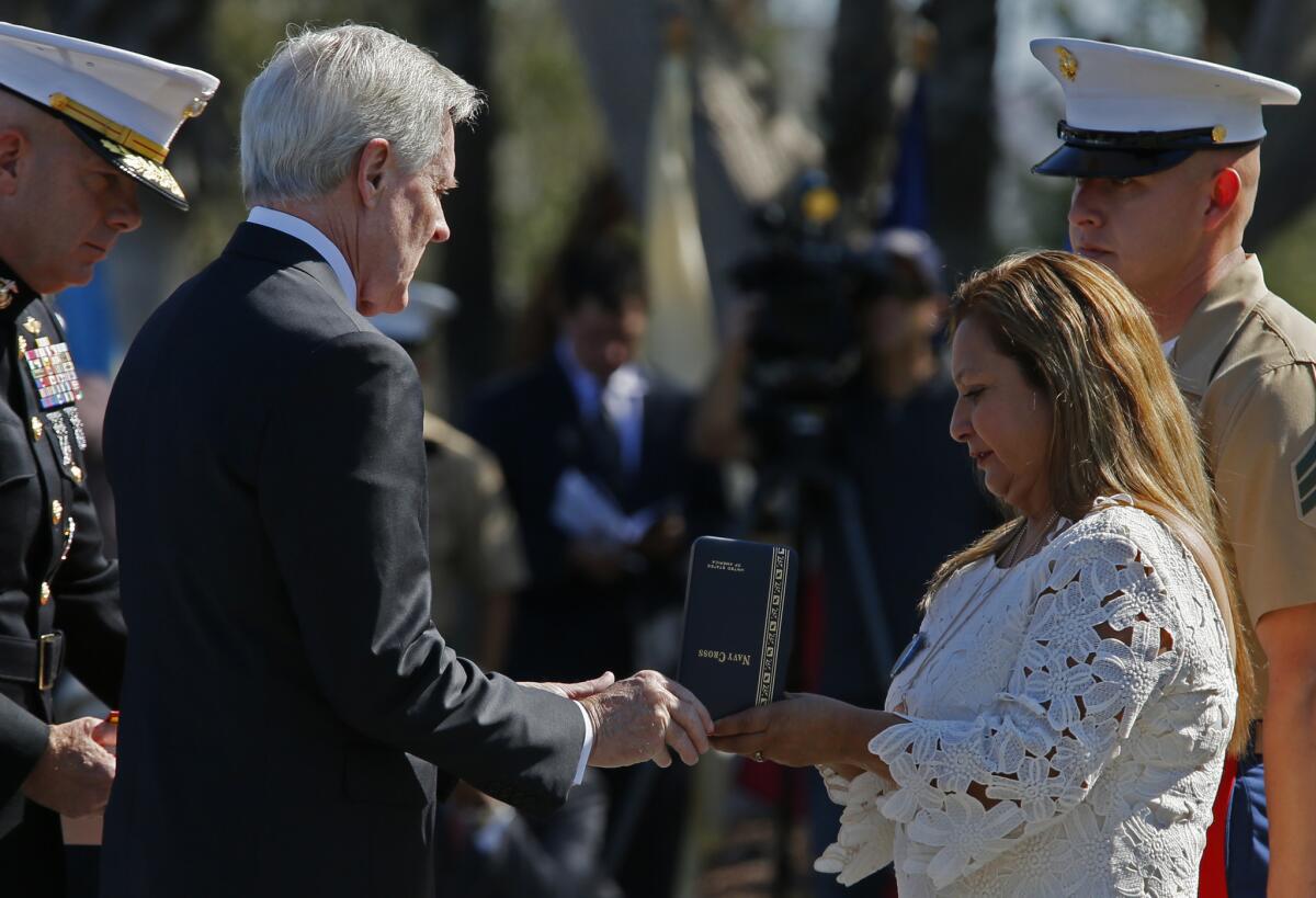 Rosa Peralta accepts the Navy Cross from Secretary of the Navy Ray Mabus on behalf of her son Marine Sgt. Rafael Peralta, who was killed in Iraq, at a ceremony at Camp Pendleton on Monday. Many say he deserved the Medal of Honor.