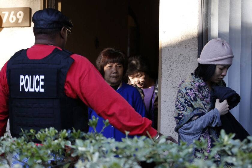 ROWLAND HEIGHTS, CA.,MARCH 3, 2015: Federal Agents serve warrants and question several residents at an apartment complex in Rowland Heights while investigating alleged birth tourism centers March 3, 2015. According to information from the Public Affairs Office of the US Department Of Homeland Security, agents from multiple federal and local law enforcement agencies executed search warrants on about 20 locations in Los Angeles, Orange and San Bernardino counties as part of an ongoing investigation into three separate alleged "maternity tourism" schemes(Mark Boster / Los Angeles Times ).