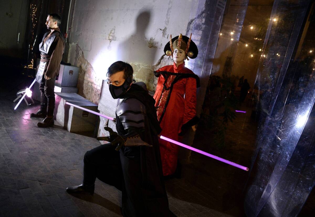 Party-goers wear "Star Wars" movie character outfits during a party in downtown Rome on the eve of the premiere of "The Force Awakens."