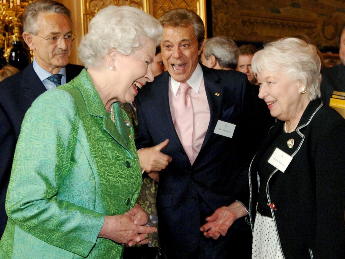FILE - Britain's Queen Elizabeth II talks with with celebrity guests Lionel Blair, centre and June Whitfield, at the Help The Aged Living Legends at Windsor Castle, in Windsor, England, Wednesday May 3 2006. Blair has died at the age of 92, it was reported on Thursday, Nov. 4, 2021. (Fiona Hanson/Pool via AP, File)