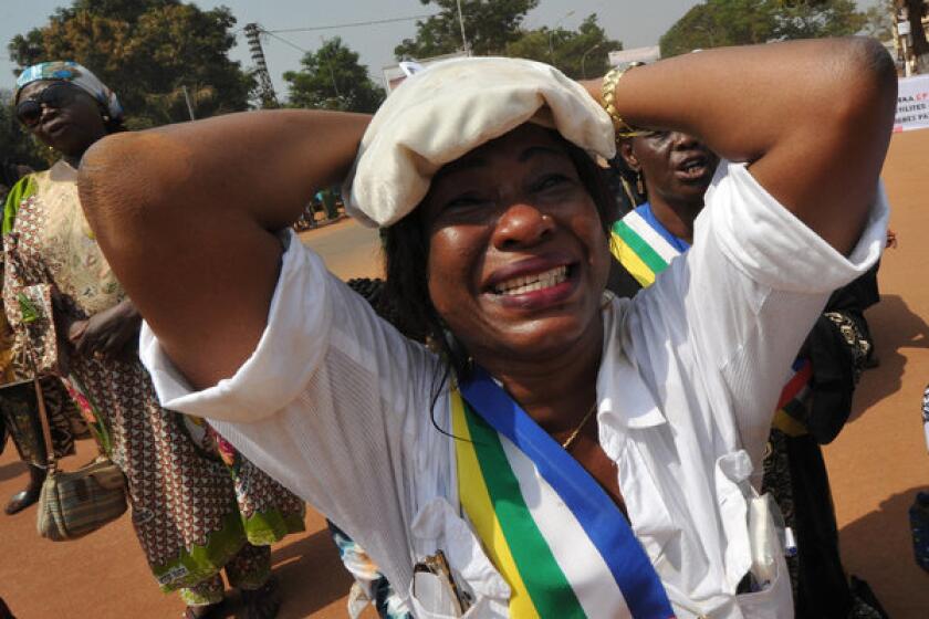 A member of the Central African Republic's national assembly cries while praying Friday during a women's protest in Bangui, the capital, against the conflict in their country.