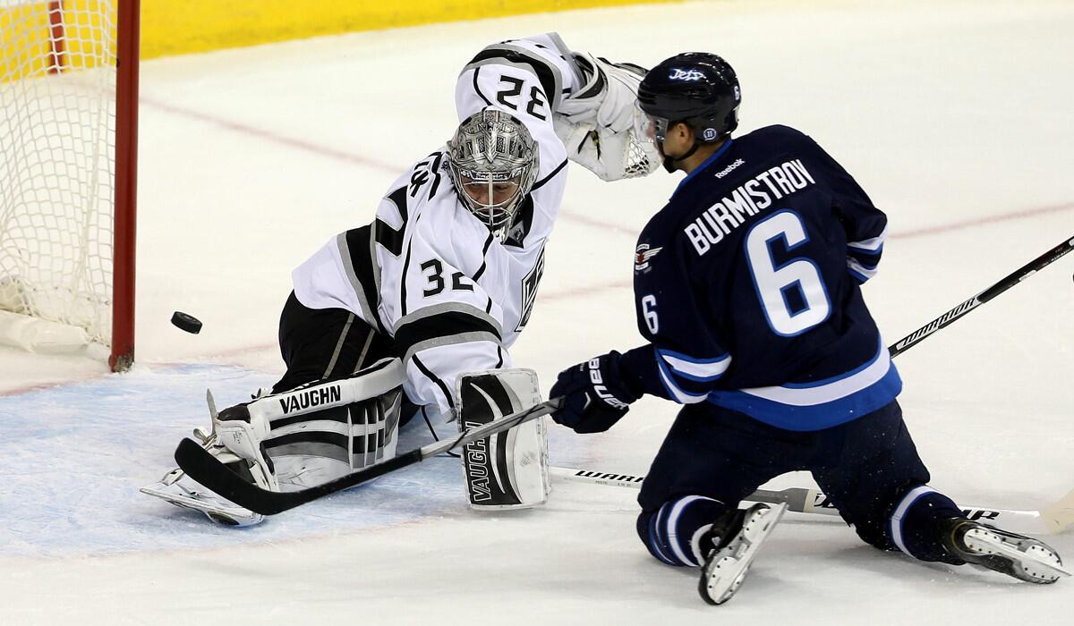 Winnipeg Jets' Alexander Burmistrov (6) can't swipe the loose puck past Los Angeles Kings' goaltender Jonathan Quick (32) during the first period on Tuesday.