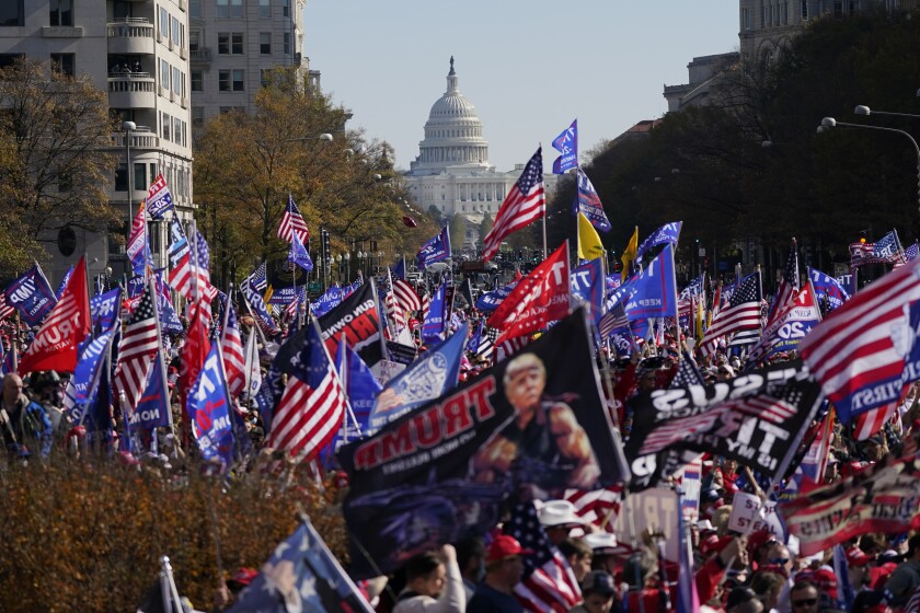 FILE - In this Nov. 14, 2020, file photo with the U.S. Capitol in the background, supporters of President Donald Trump rally at Freedom Plaza in Washington. (AP Photo/Julio Cortez, File)