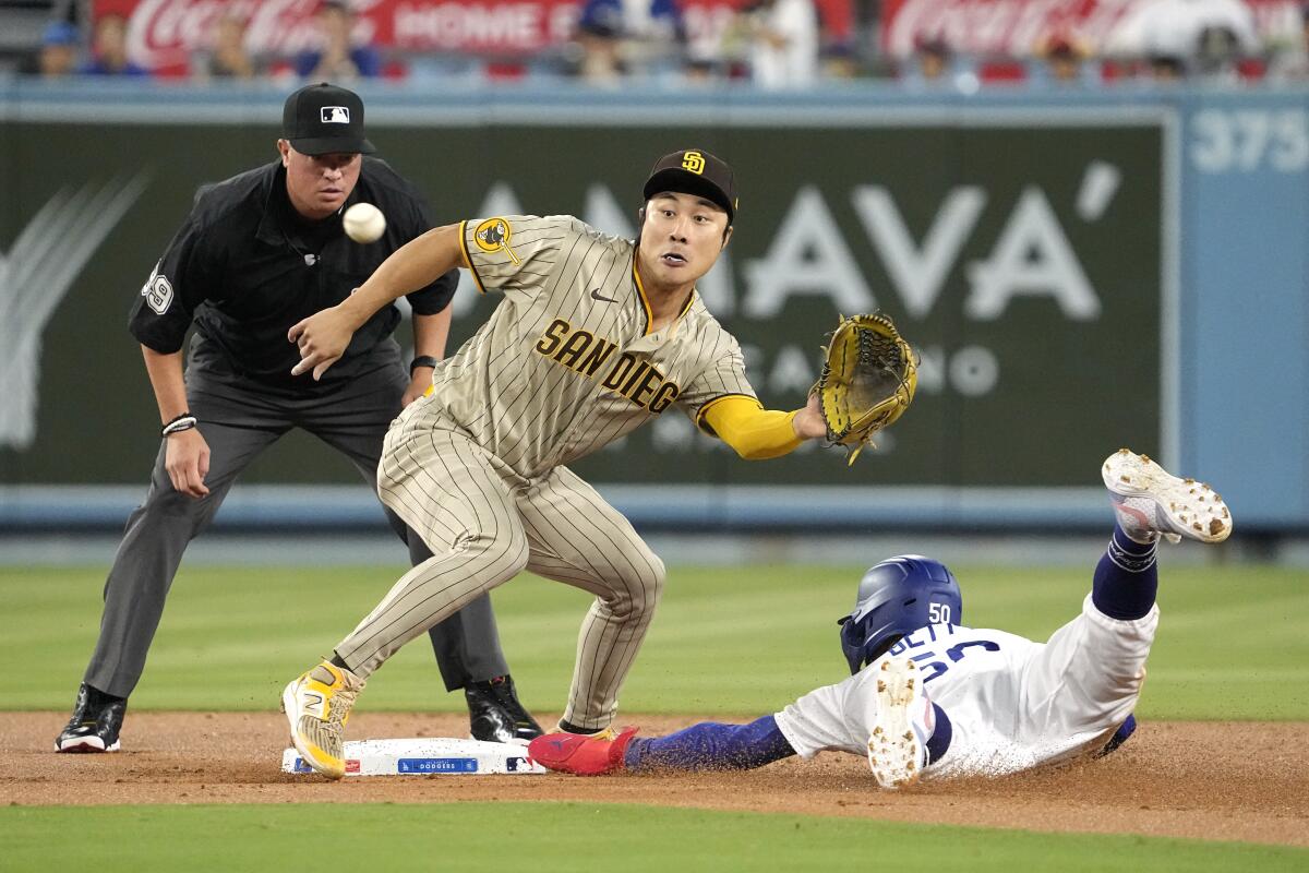 The Dodgers' Mookie Betts steals second as San Diego Padres shortstop Ha-Seong Kim takes a late throw.