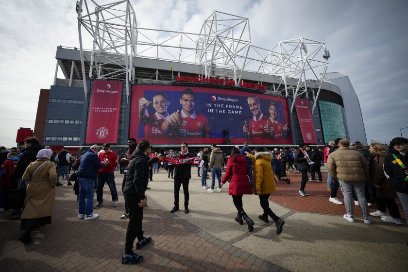 Fans outside the Old Trafford stadium in Manchester ahead the English Premier League soccer match between Manchester United and Southampton, England, Sunday, March 12, 2023. (AP Photo/Jon Super)