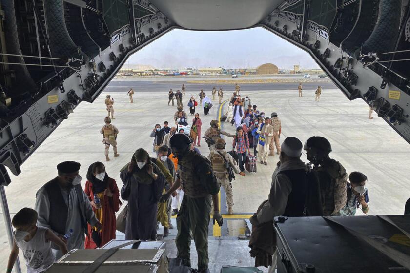 In this photo provided by the Spanish Defence Ministry and taken in Kabul, Afghanistan, people board a Spanish airforce A400 plane as part of an evacuation plan at Kabul airport in Afghanistan, Wednesday Aug. 18, 2021. (Spanish Defence Ministry via AP)