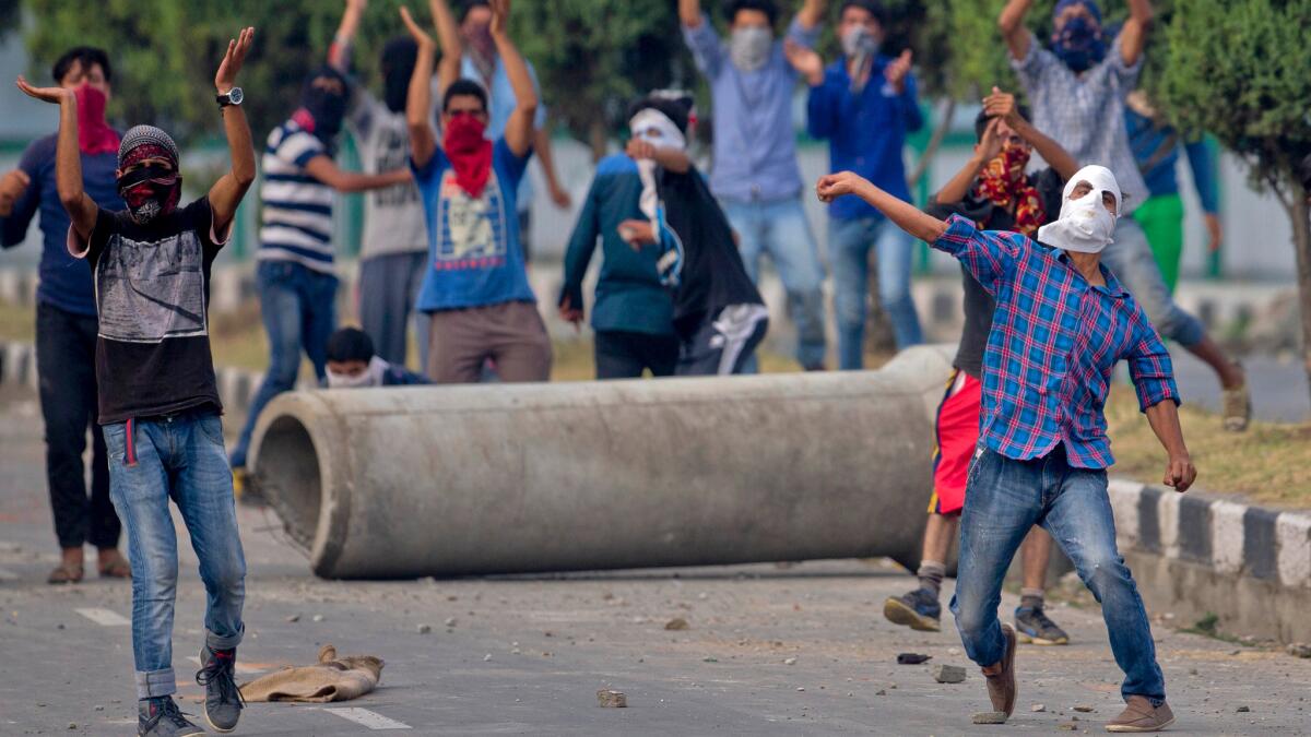 A protester throws stones during clashes with Indian troops in Srinagar, Indian-administered Kashmir, on July 12.