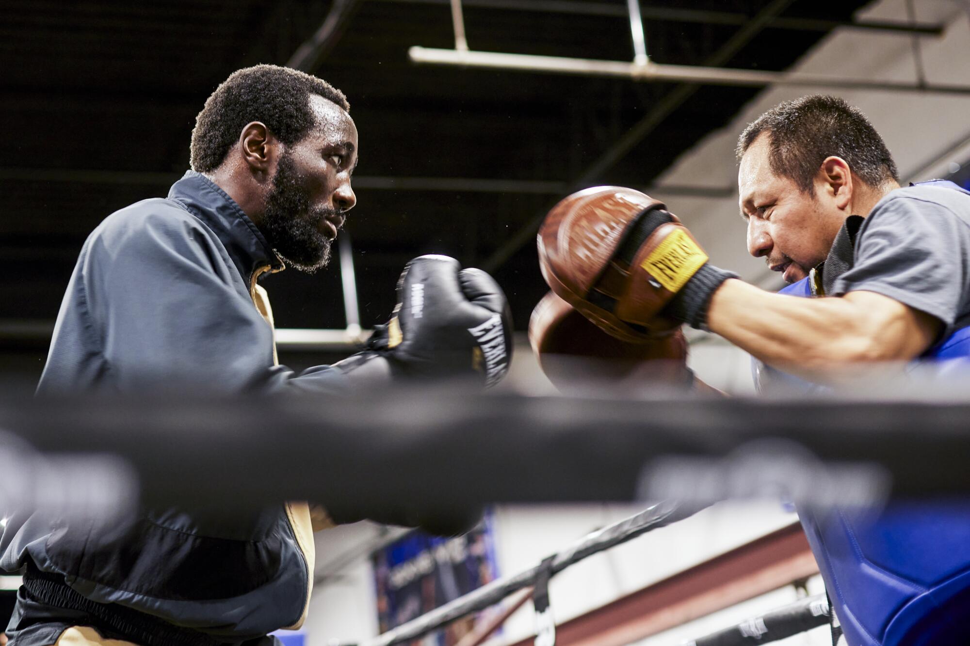 Terence "Bud" Crawford works with assistant trainer Esau "El Tuto" Dieguez at the Triple Threat Boxing Gym 