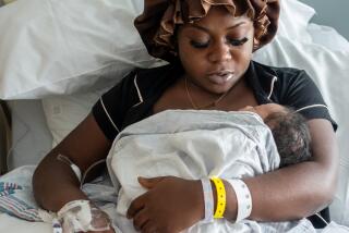 Brianna McKenzie, 23, holds her newborn baby boy in the Labor & Delivery Unit at MLK Community Hospital