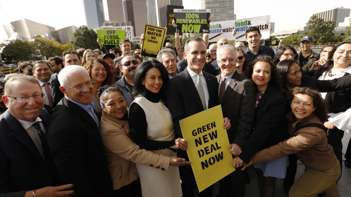 Los Angeles Mayor Eric Garcetti poses for photos after a news conference outside Department of Water and Power headquarters in February.