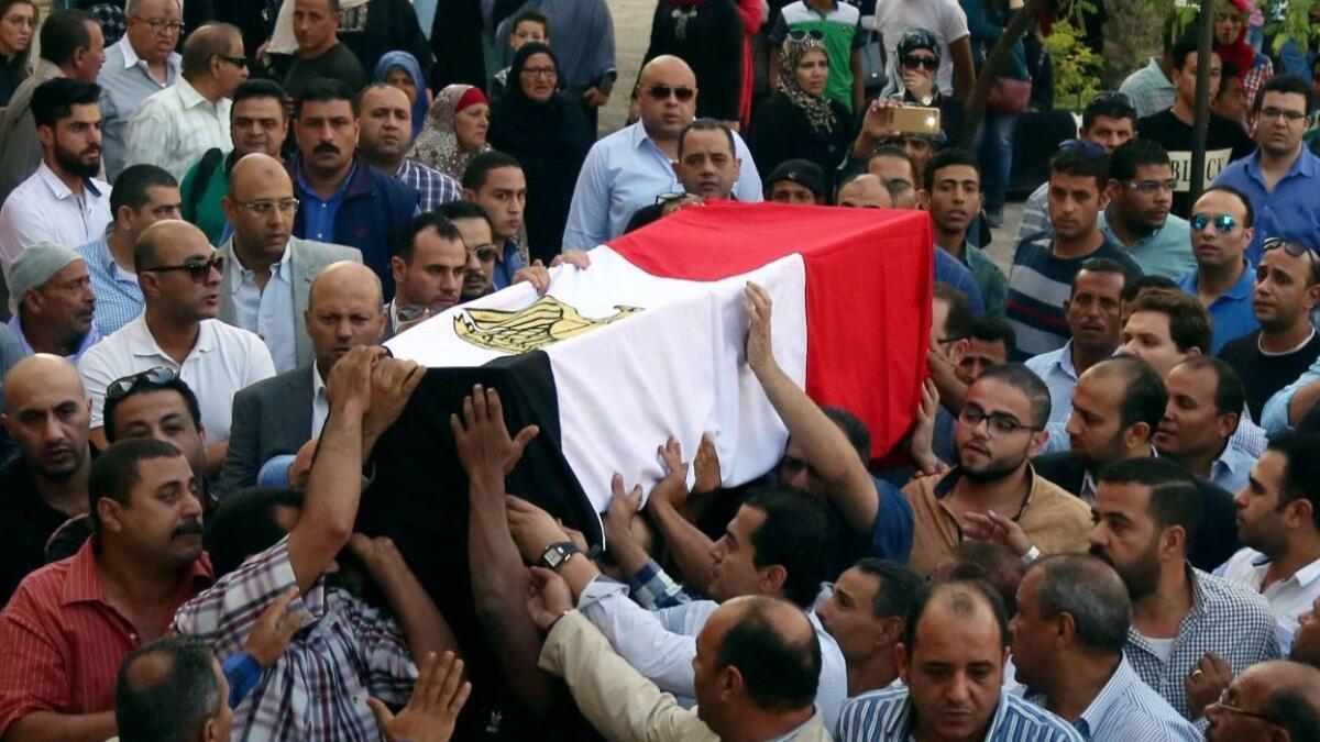 The coffin of a police captain killed in a firefight in the al-Wahat al-Bahriya area in Giza province, during his funeral in Cairo, Egypt, Saturday, Oct. 21, 2017.