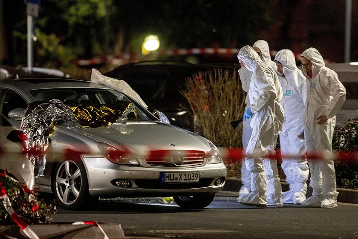 Forensic investigators at the scene after a shooting in central Hanau, Germany, on Thursday.