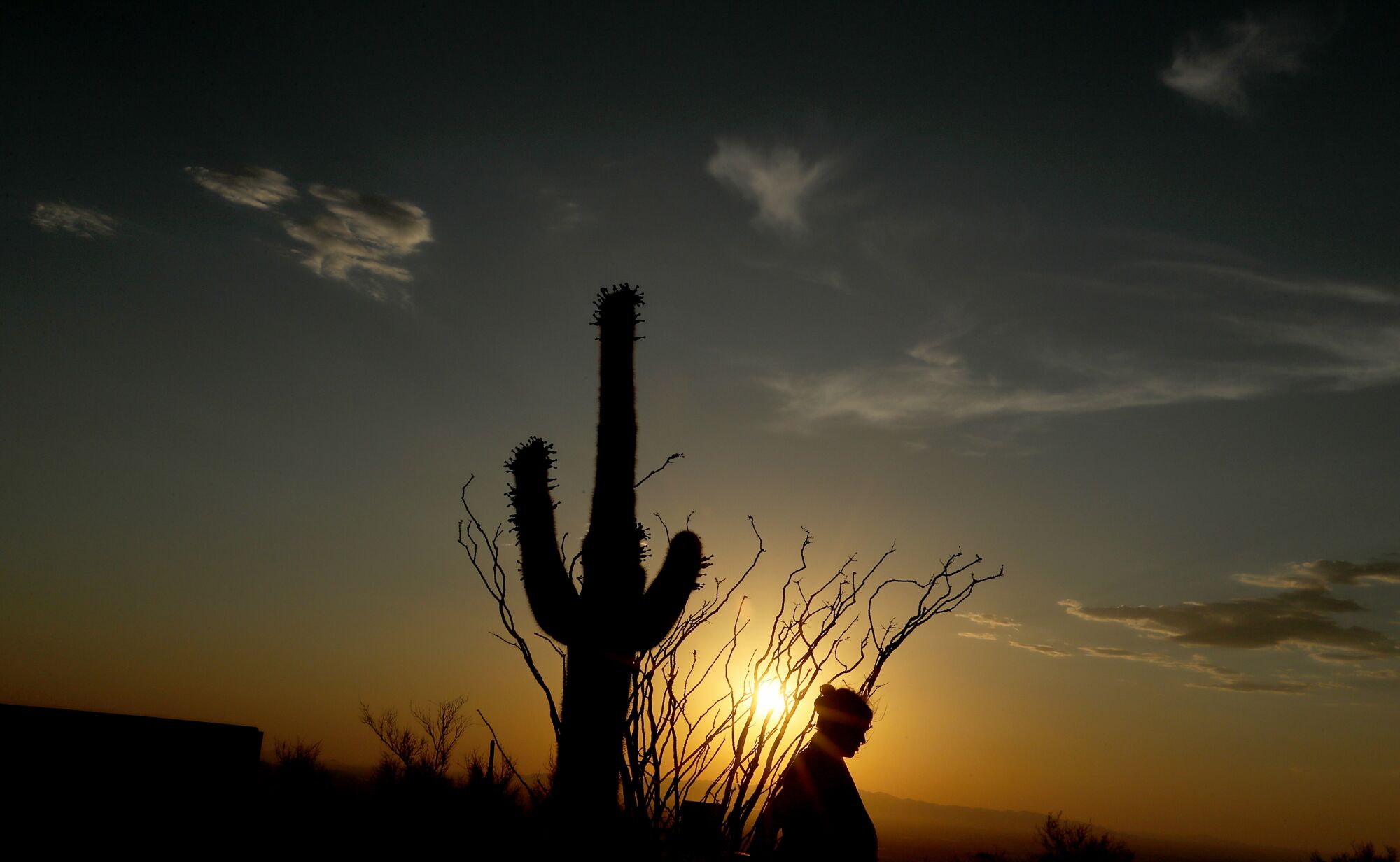 A visitor walks around Dobbins Lookout above Phoenix, now the fifth largest city in the U.S.