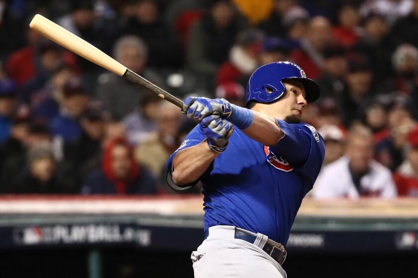 Cubs designated hitter Kyle Schwarber (12) hits an RBI single to score a run during the third inning of Game 2 on Oct. 26.
