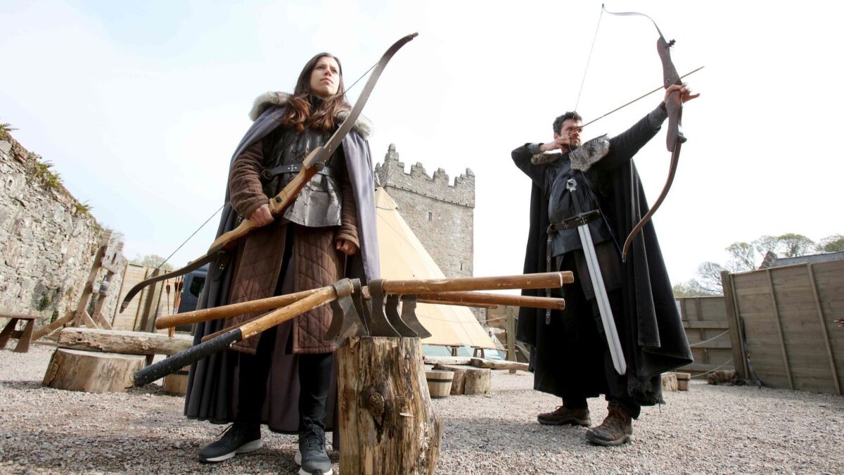 French Game of Thrones fans, Claire Pottier from left, and Hugo Chivard from Normandy, take part in archery at the Castle Ward Estate in Strangford, northern Ireland, the location of Winterfell in Game of Thrones. (Paul Faith / AFP / Getty Images)