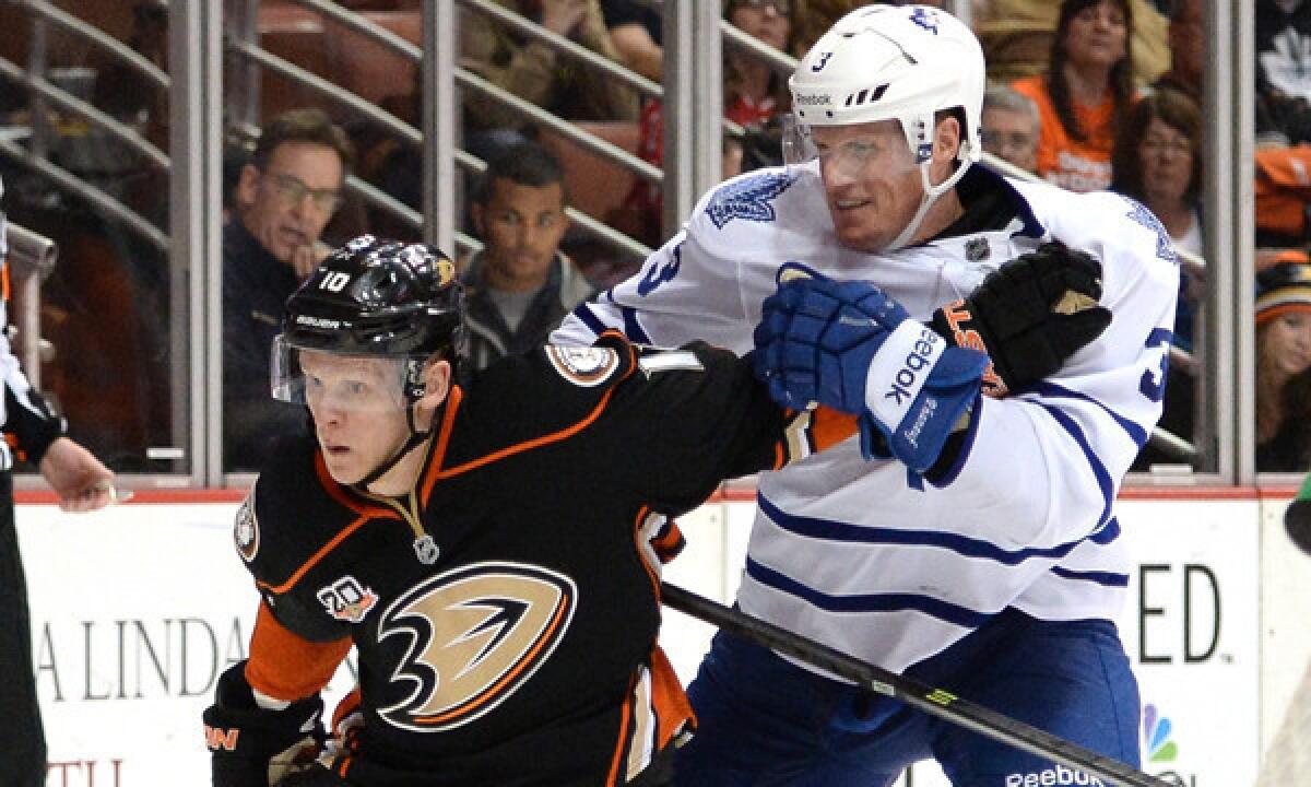 Ducks forward Corey Perry fends off Toronto Maple Leafs defenseman Dion Phaneuf during the Ducks' 3-1 loss Monday. The Ducks have struggled since returning from the Olympic break.