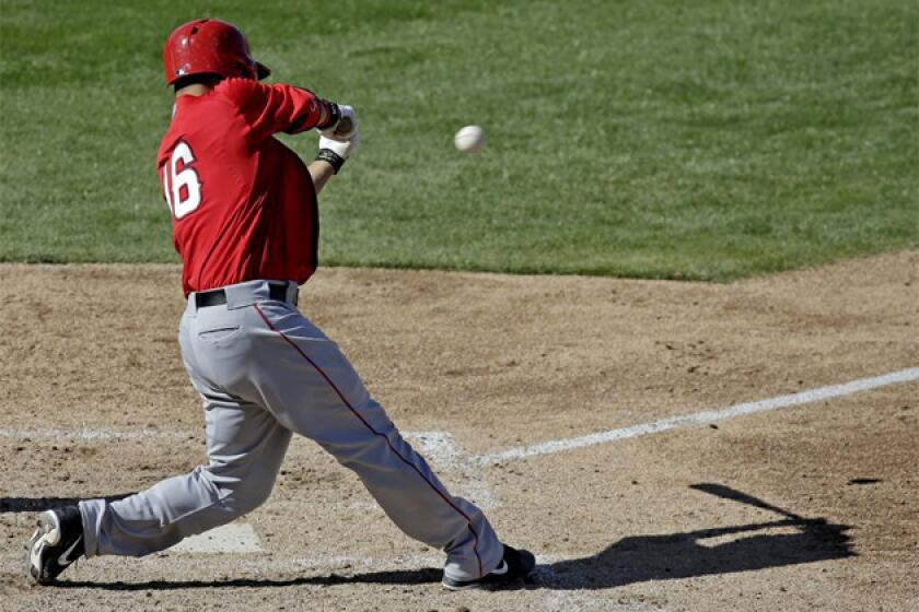 Angels catcher Hank Conger hits a two-run single during the sixth inning of an exhibition game against the Milwaukee Brewers.