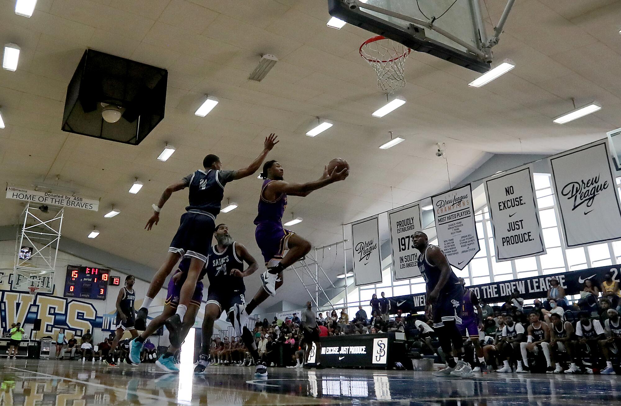Two teams play a Drew League game at St. John Bosco High on June 26.