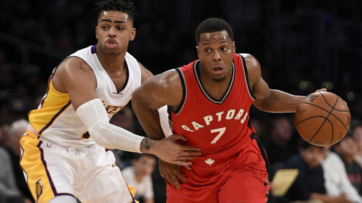 Raptors guard Kyle Lowry drives past Lakers guard D'Angelo Russell during the first half Sunday.