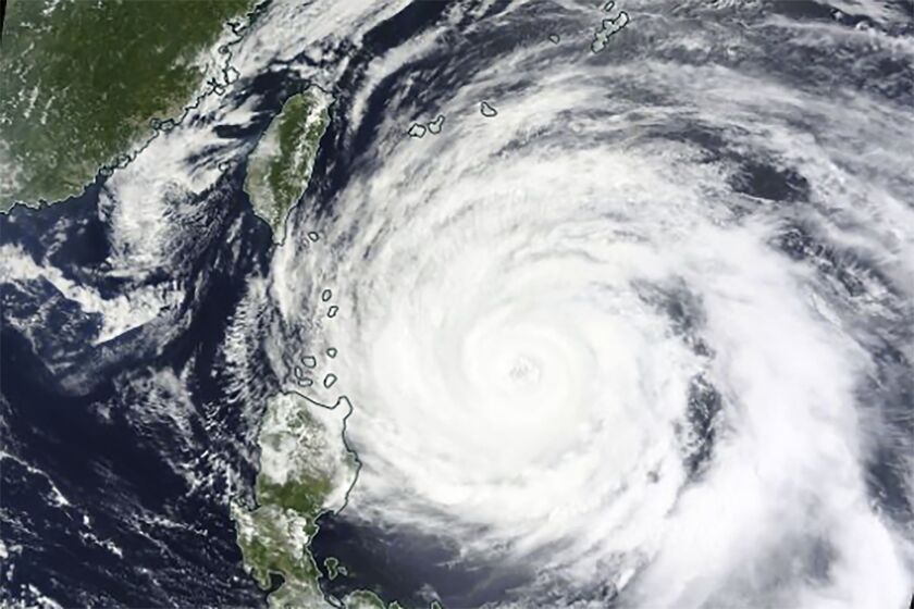 This Monday, May 29, 2023 satellite image released by NASA shows Typhoon Mawar approaching Philippines' northern provinces. (NASA Worldview, Earth Observing System Data and Information System (EOSDIS) via AP)