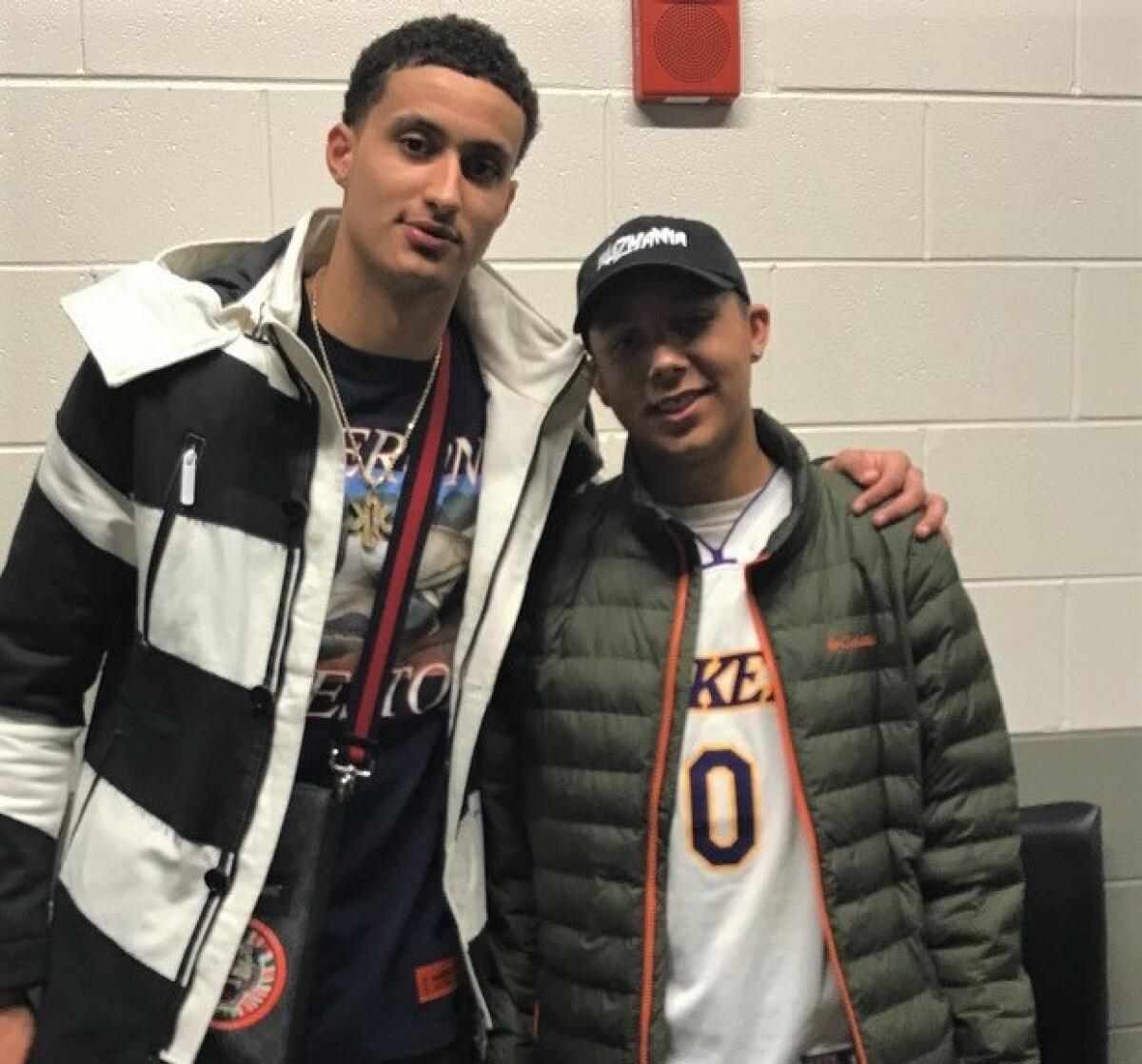 Brothers Kyle Kuzma and Andre Smith pose for a photo.