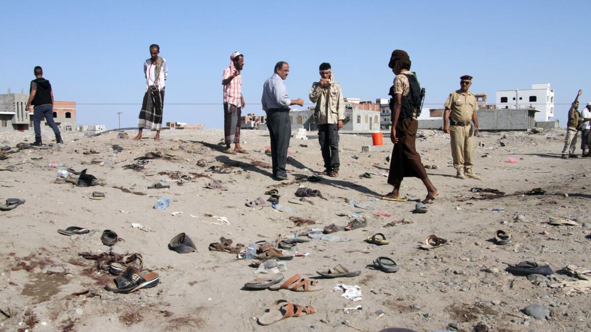Yemenis gather at Sawlaba base in Aden's Arish district after a bomber targeted a crowd of soldiers.