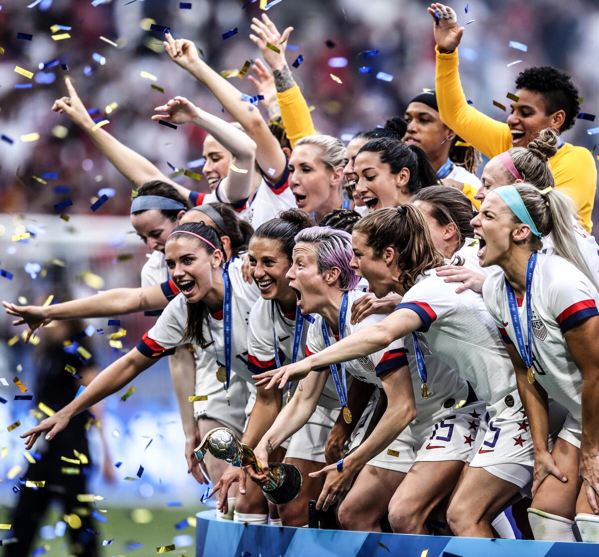 Megan Rapinoe holds the FIFA Women's World Cup trophy following team USA's victory in the 2019 World Cup Final match between the U.S. and the Netherlands.