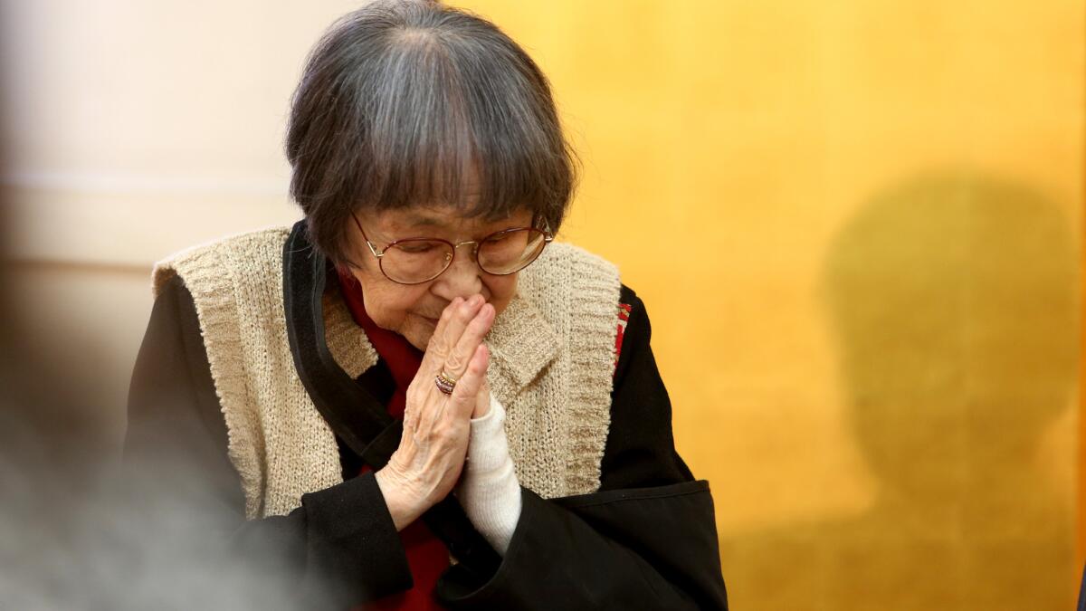 Hiroshima bombing survivor Kaz Suyeishi listens to others talk of their experiences at a press conference of the American Society of Hiroshima-Nagasaki A-Bomb Survivors.