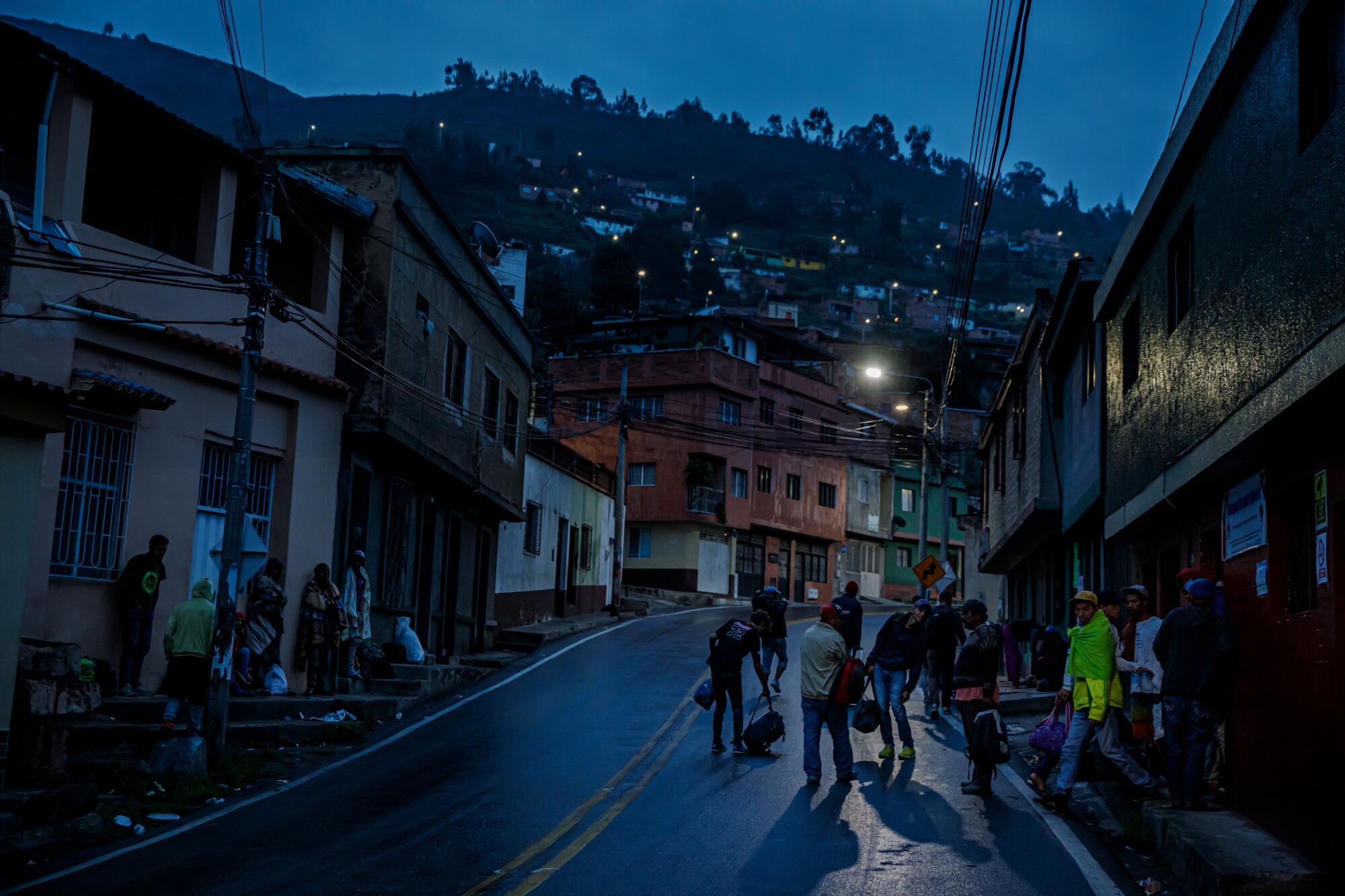 Venezuelan migrants start their day before sunrise as they leave a shelter in Pamplona, Colombia, in May 2019.