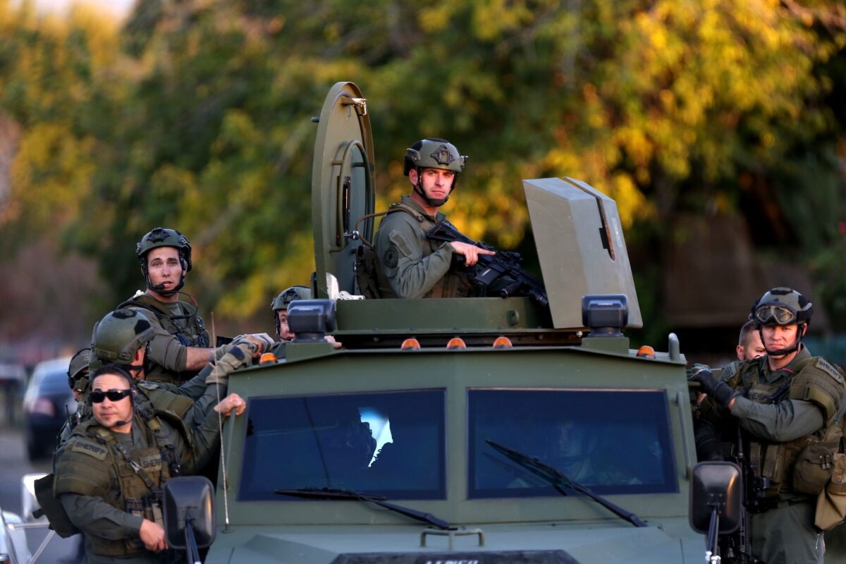 A SWAT vehicle carries police officers near the scene of a shooting in San Bernardino on Dec. 2.
