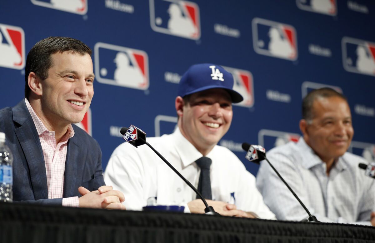 Andrew Friedman, the Dodgers' president of baseball operations, fields questions along with pitcher Rich Hill, center, and Manager Dave Roberts, right, during a Dec. 5 news conference in Oxon Hill, Md., to announce Hill's signing.