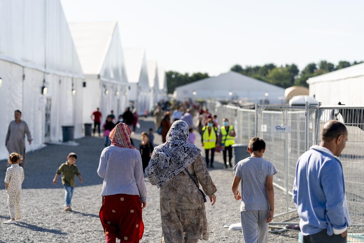 Afghan refugees walk through an Afghan refugee camp in New Jersey.