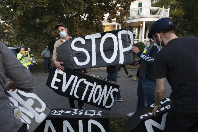 FILE - In this Oct. 14, 2020, file photo, housing activists erect a sign in Swampscott, Mass. A federal freeze on most evictions is set to expire soon. The moratorium, put in place by the Centers for Disease Control and Prevention in September, was the only tool keeping millions of tenants in their homes. (AP Photo/Michael Dwyer, File)