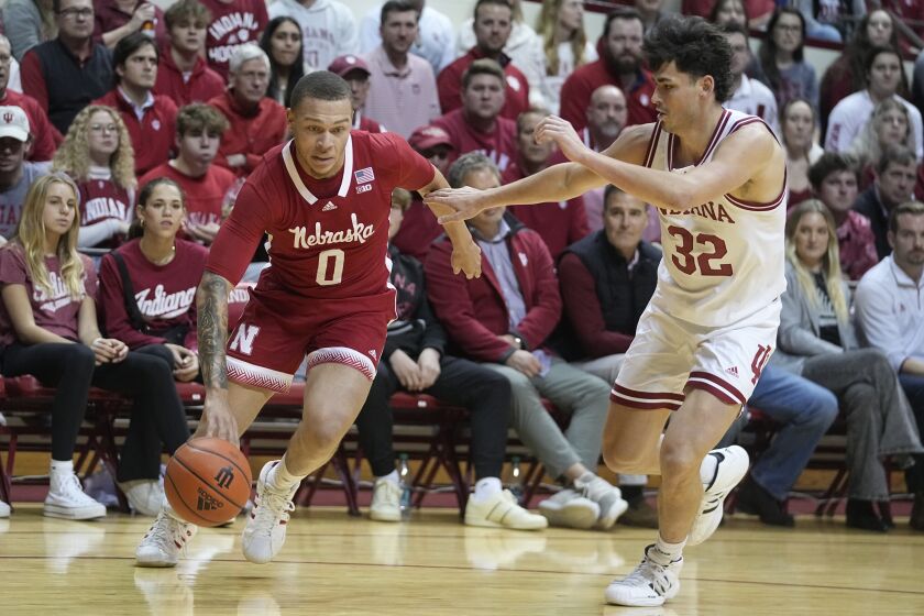 Nebraska's C.J. Wilcher (0) drives against Indiana's Trey Galloway (32) during the first half of an NCAA college basketball game Wednesday, Dec. 7, 2022, in Bloomington, Ind. (AP Photo/Darron Cummings)