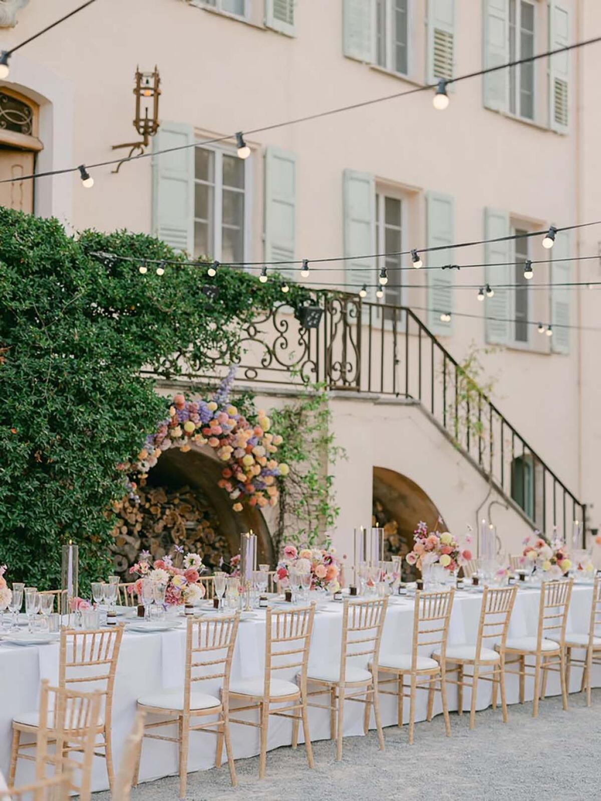 A wedding reception banquet table set up alongside the Bastide du Roy.