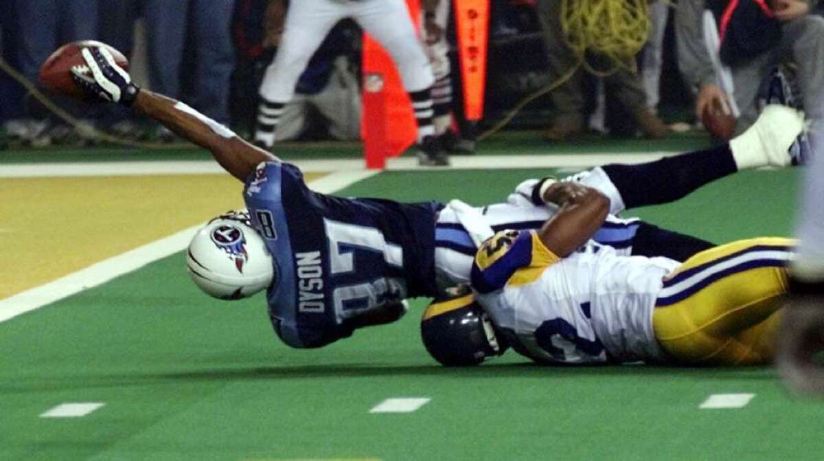 Tennessee Titans wide receiver Kevin Dyson tries but fails to get the ball into the end zone as he is tackled by the St. Louis Rams' Mike Jones on the final play of Super Bowl XXXIV.